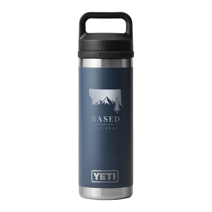 A navy 18 oz insulated bottle with the BASED mountains engraved in bare silver metal